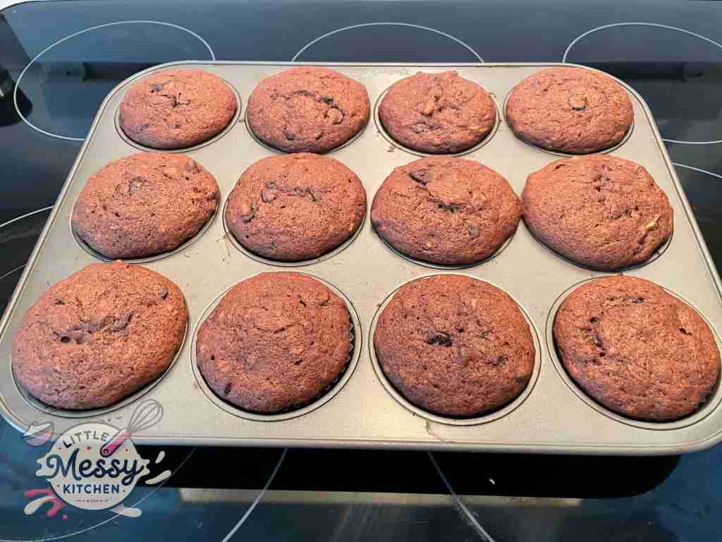 Banana chocolate muffin fresh out of the oven in muffin pan.