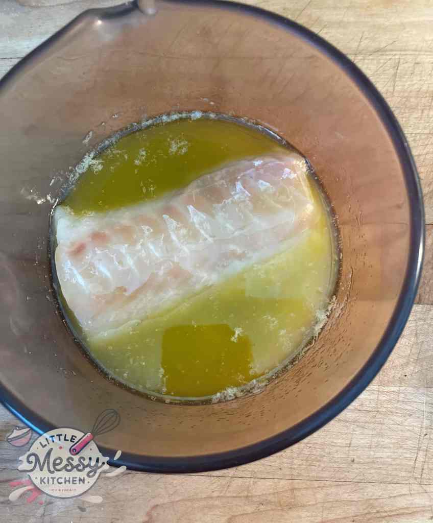 Cod filet in melted butter mixture.
