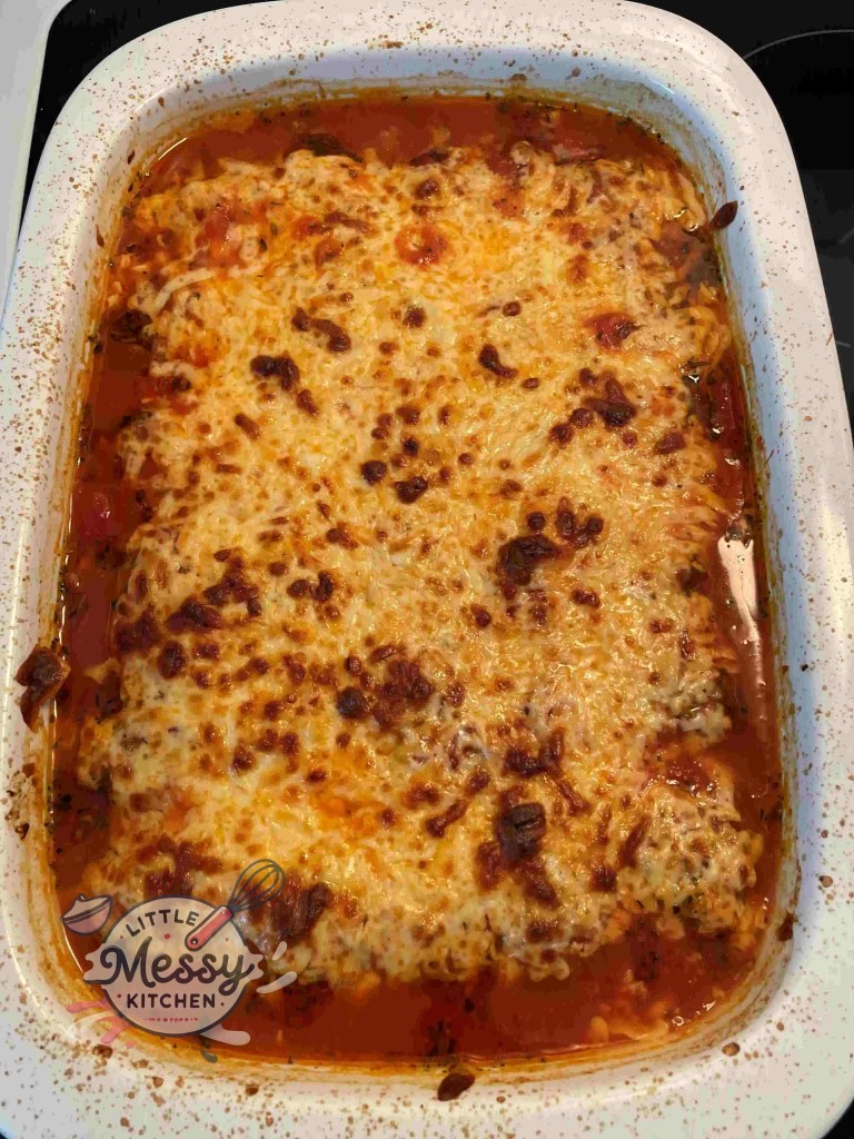 Baked meatball dish topped with crispy, melted cheese fresh out of the oven.