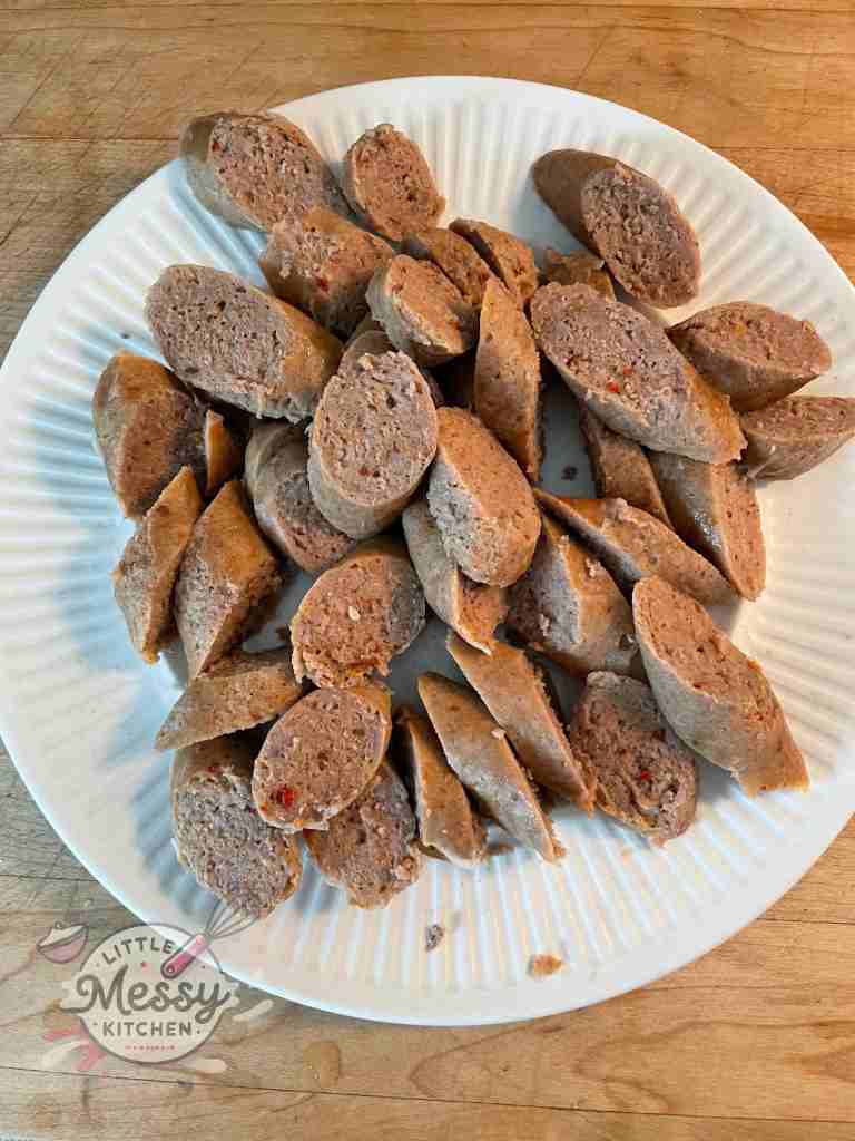 Sliced sausages arranged on a plate.