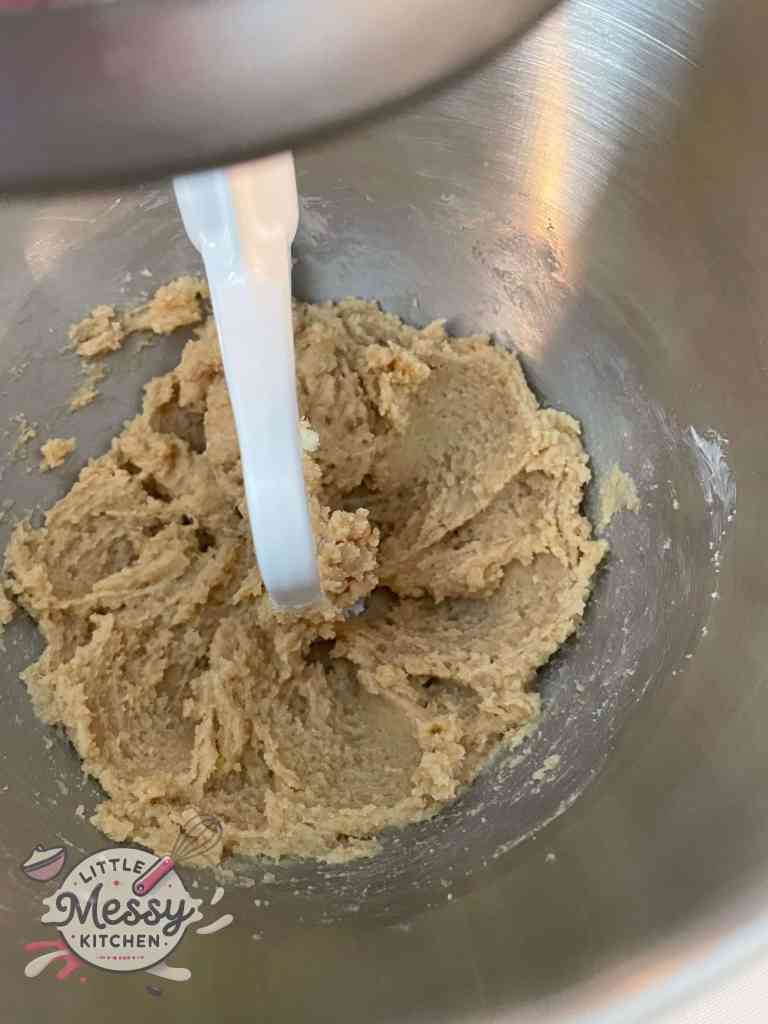 Butter, sugar, and brown sugar mixed in a stand mixer.