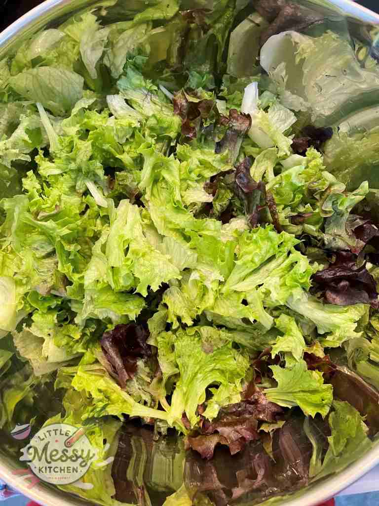Red and green lettuce mixed in a bowl.