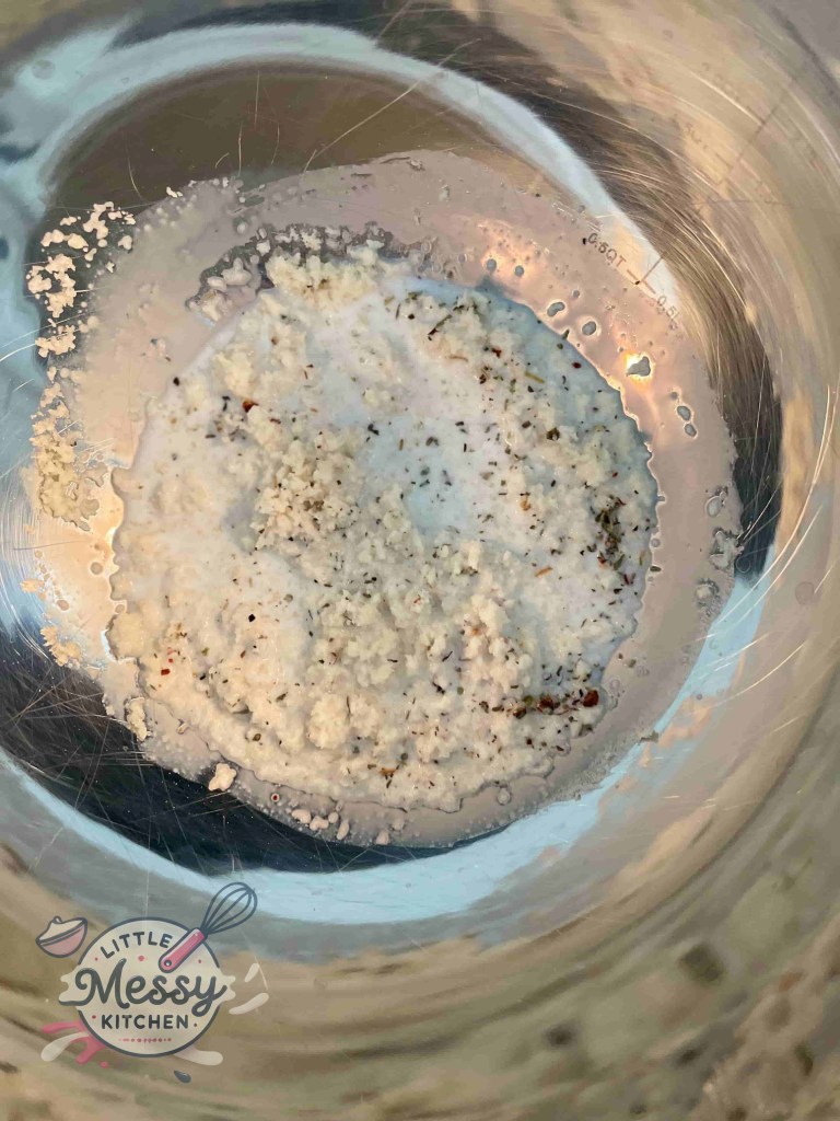 Small bowl with Italian breadcrumbs, dried oregano, salt, black pepper, and milk mixture.