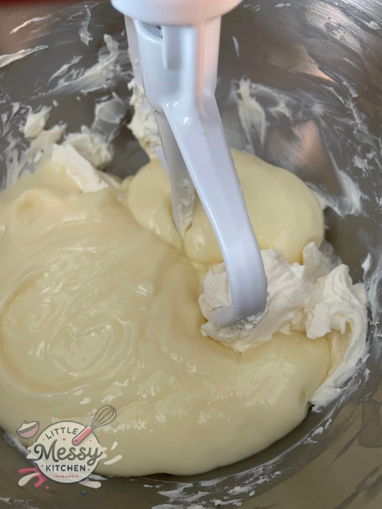 Cream cheese and vanilla pudding mix in a stand mixer.
