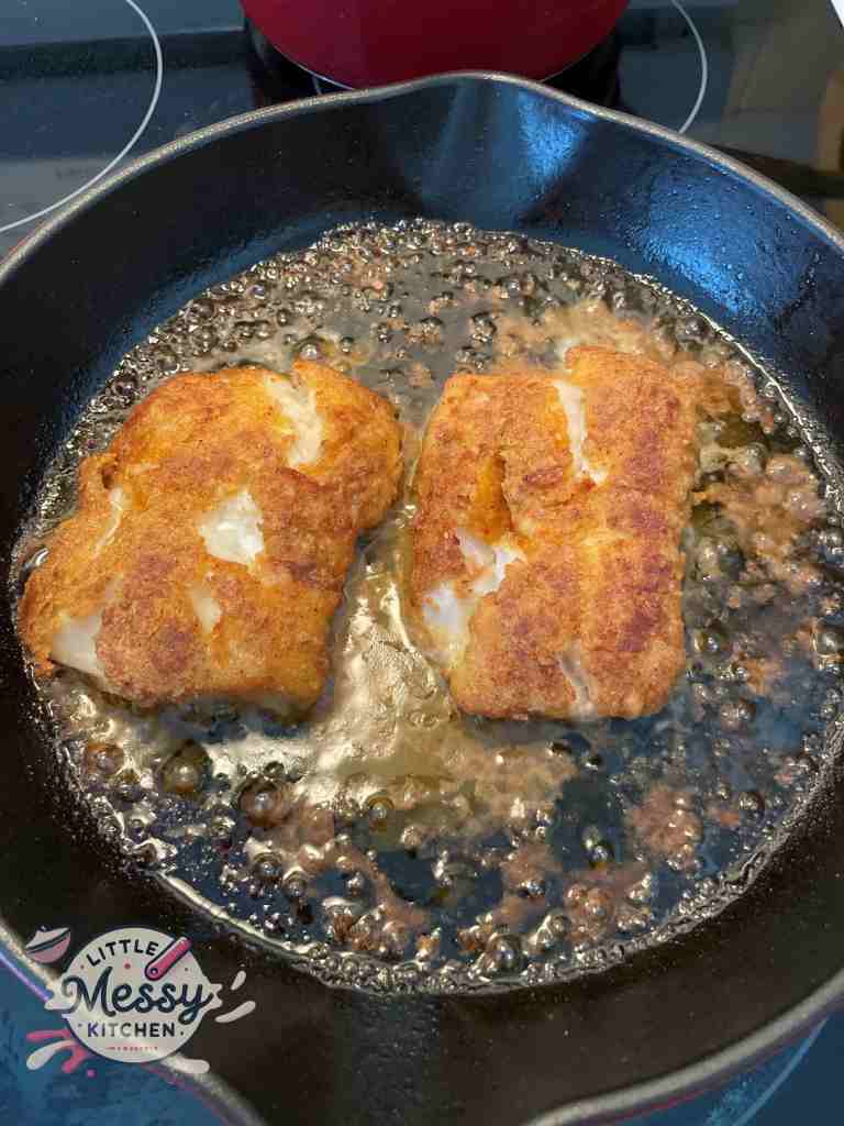 cod filet in cast iron skillet just out of the oven.