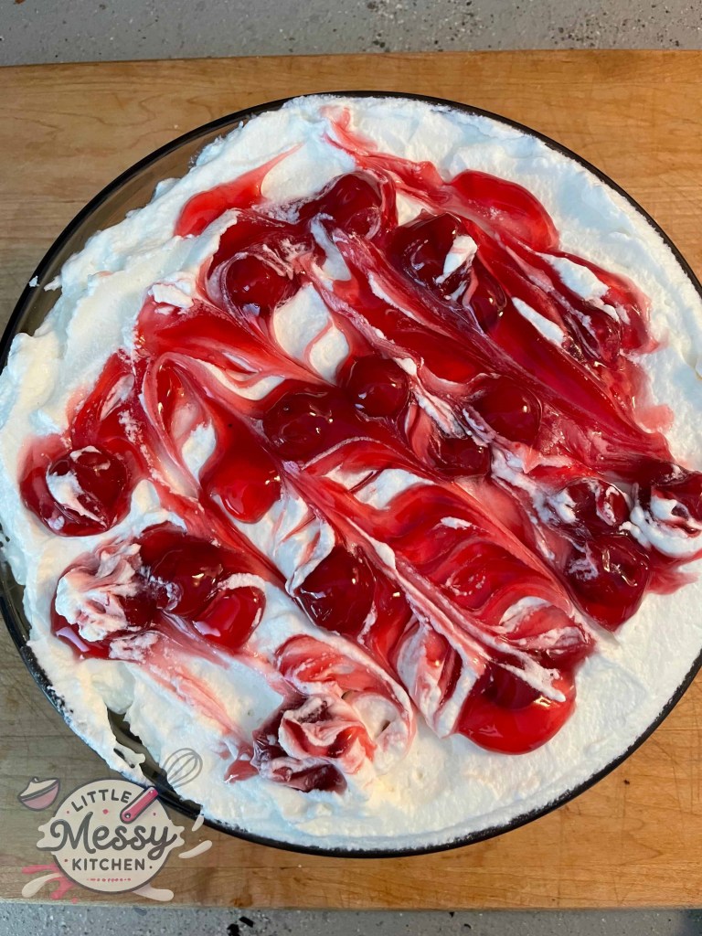 Top view of Cherry Cream Delight dish with whipped cream and cherry pie filling.