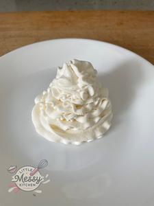 Stabilized whipped cream, piped on a plate.