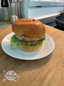 Chicken burger on a serving plate.
