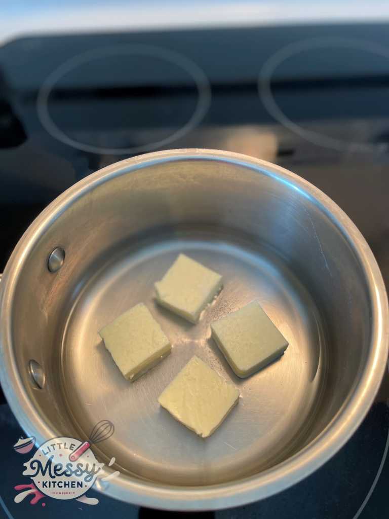 1/2 cup of butter, 1 cup of water and 1/4 tsp of salt in a saucepan ready to be boiled.