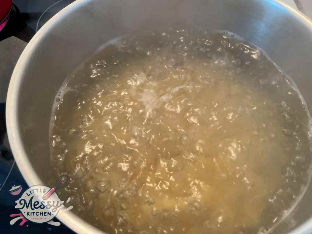 Pasta cooking in a pot of boiling water.