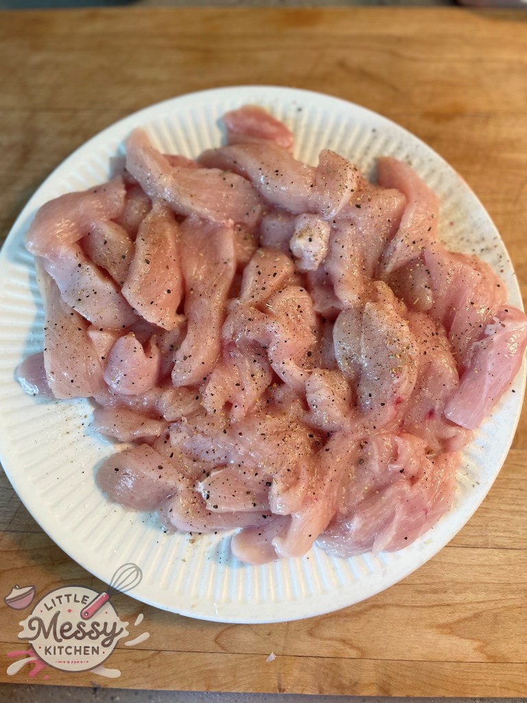 Sliced chicken topped with spices in a plate.