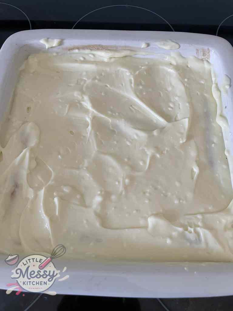 Cream filling layered on top of pastry layer.