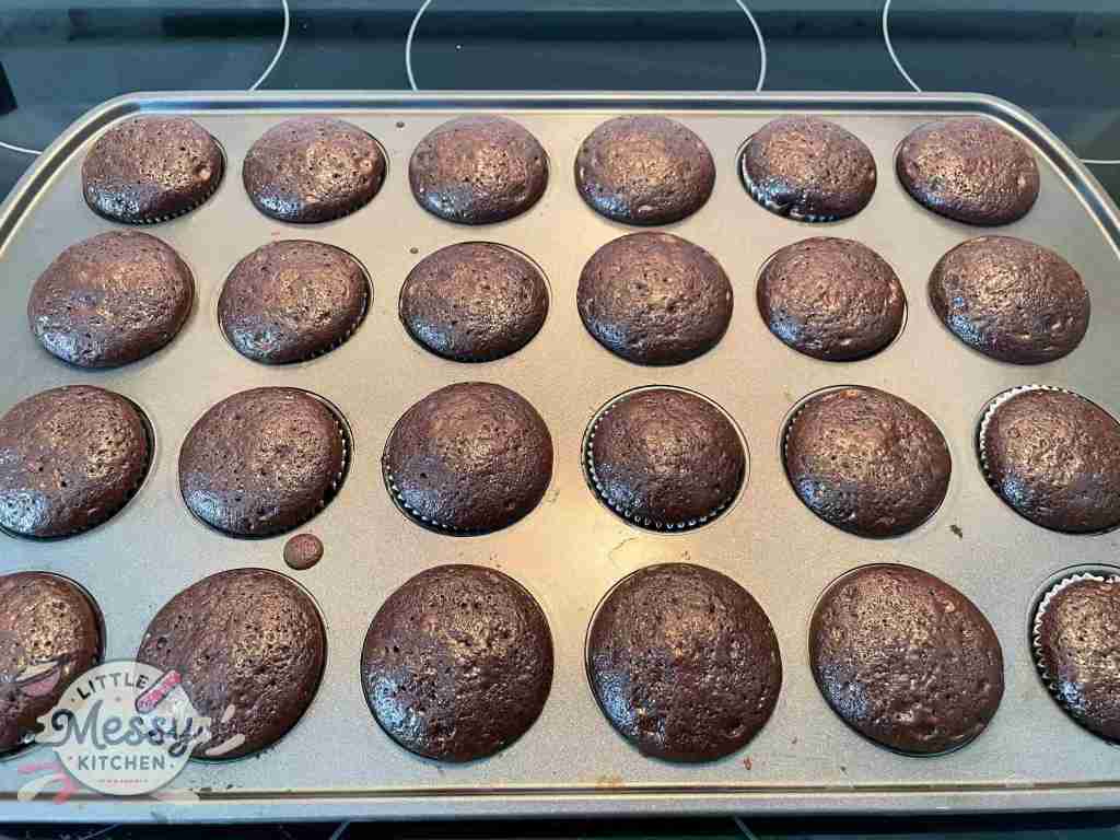 Cooked chocolate cupcake in muffin pan cooling.