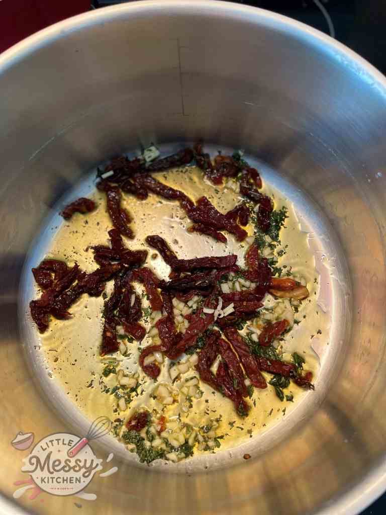 Sundried tomatoes garlic and parsley in a stockpot