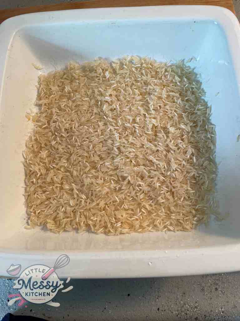 Uncooked rice in a baking dish.