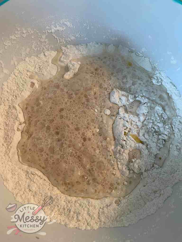 Flour and yeast mixture in a bowl ready to be combined.