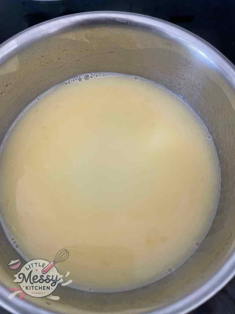 Milk and melted butter combined in a saucepan on the stove.