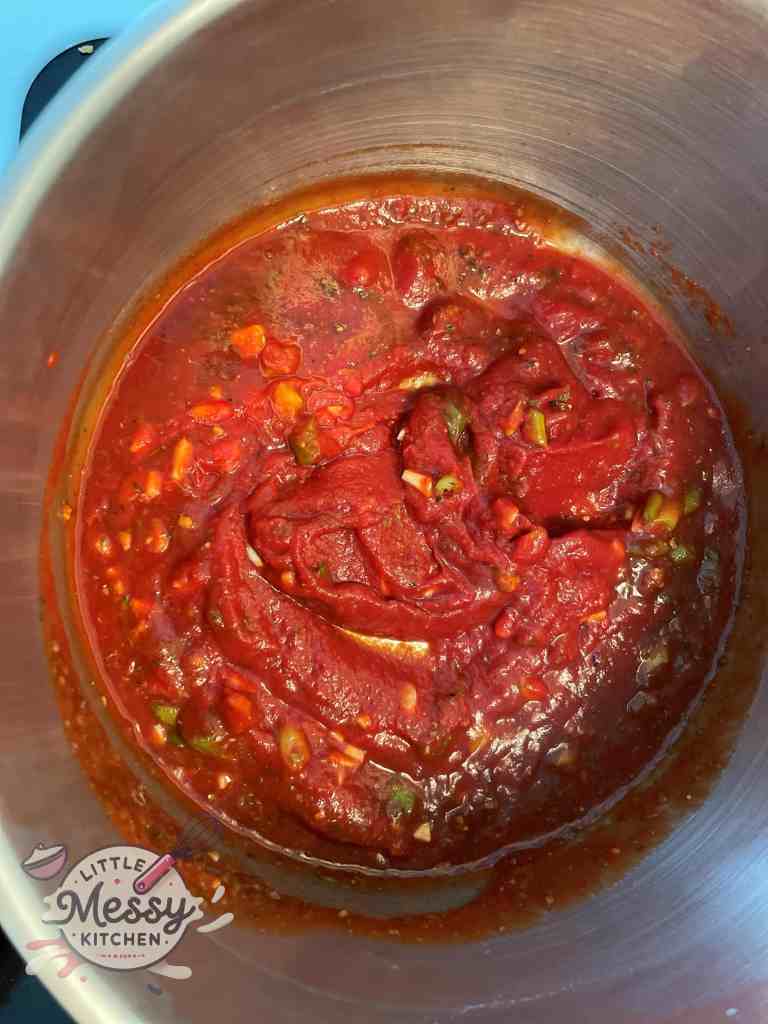 Sauce ingredients combined and cooking in a pot.