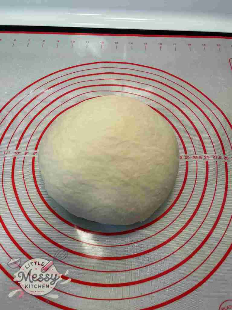 Kneaded dough on a pastry mat.