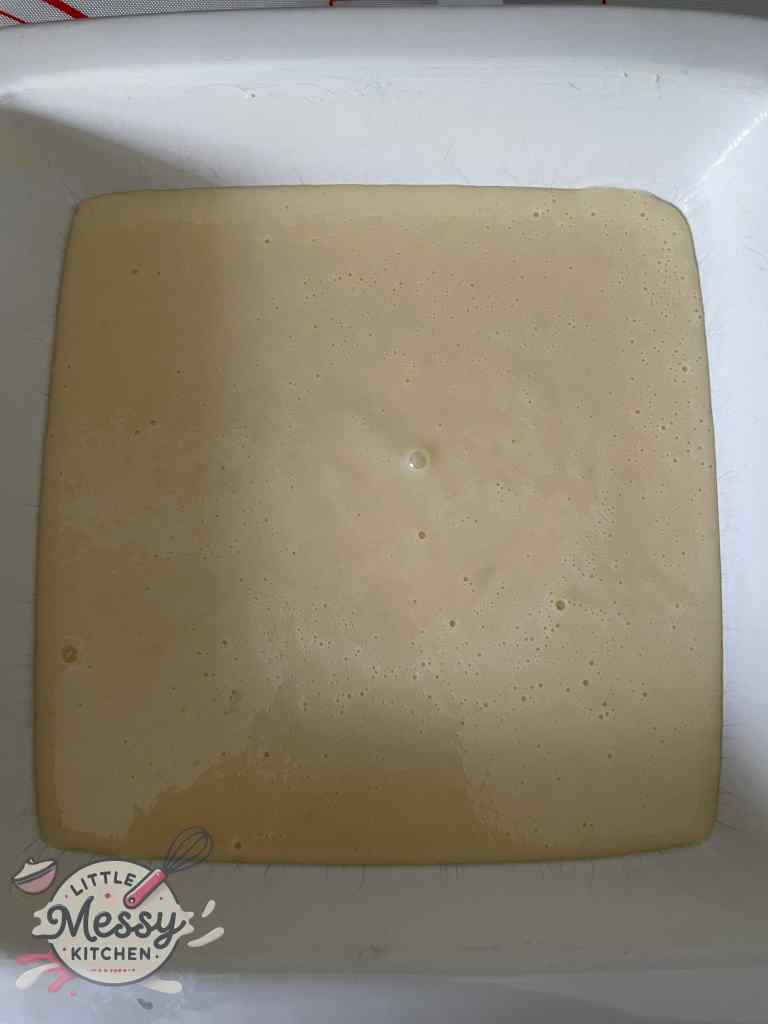 Dough mixture poured in baking dish ready to be baked.