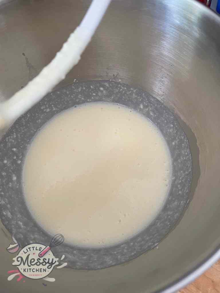 Butter, sugar, sour cream, eggs, and vanilla extract mixed together in a large bowl.