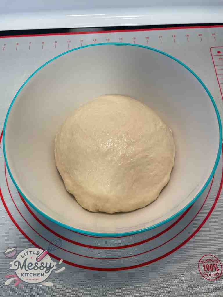 Bread dough in a slightly oiled bowl.