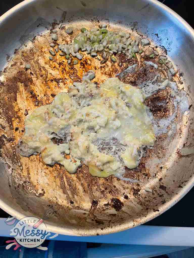 Eggs scrambled in frying pan.