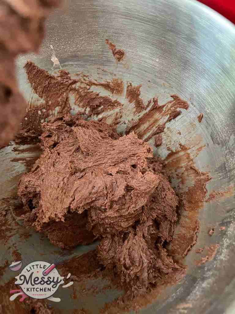Dry ingredients folded into the wet ingredients in a mixing bowl.