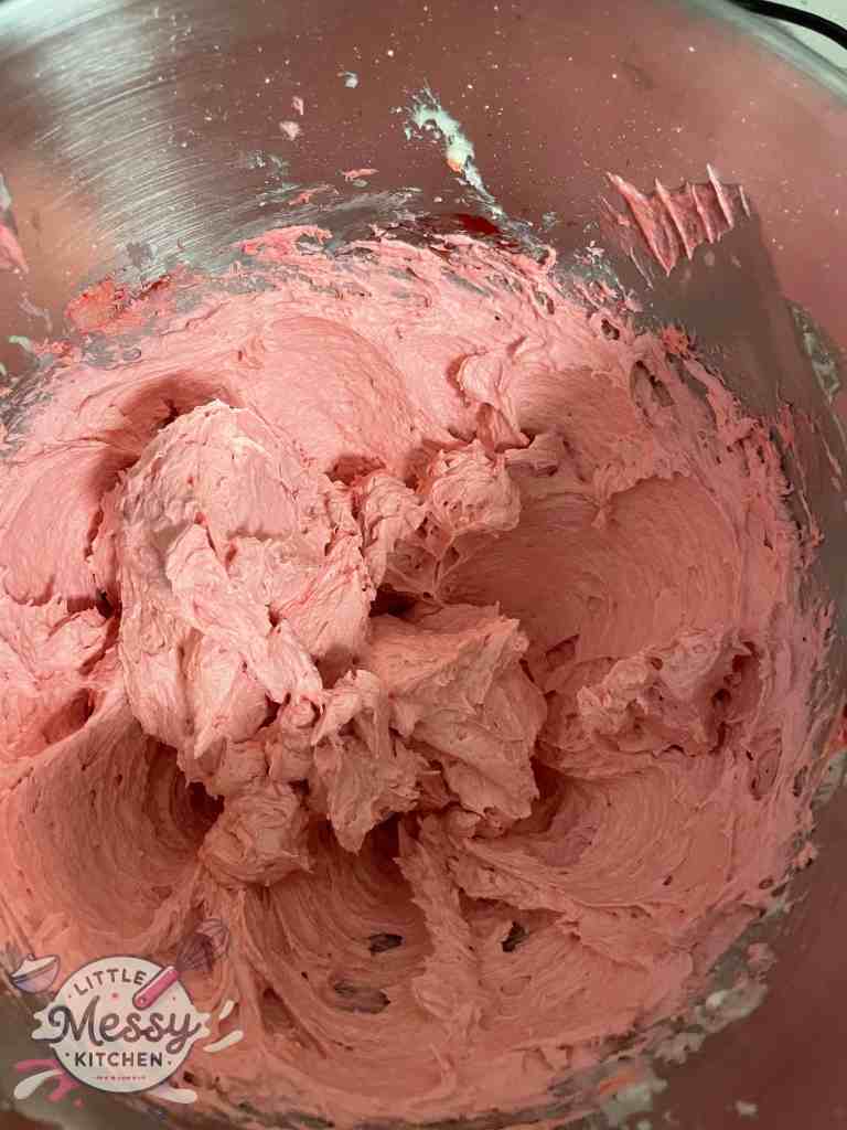 Raspberry buttercream frosting in a mixing bowl