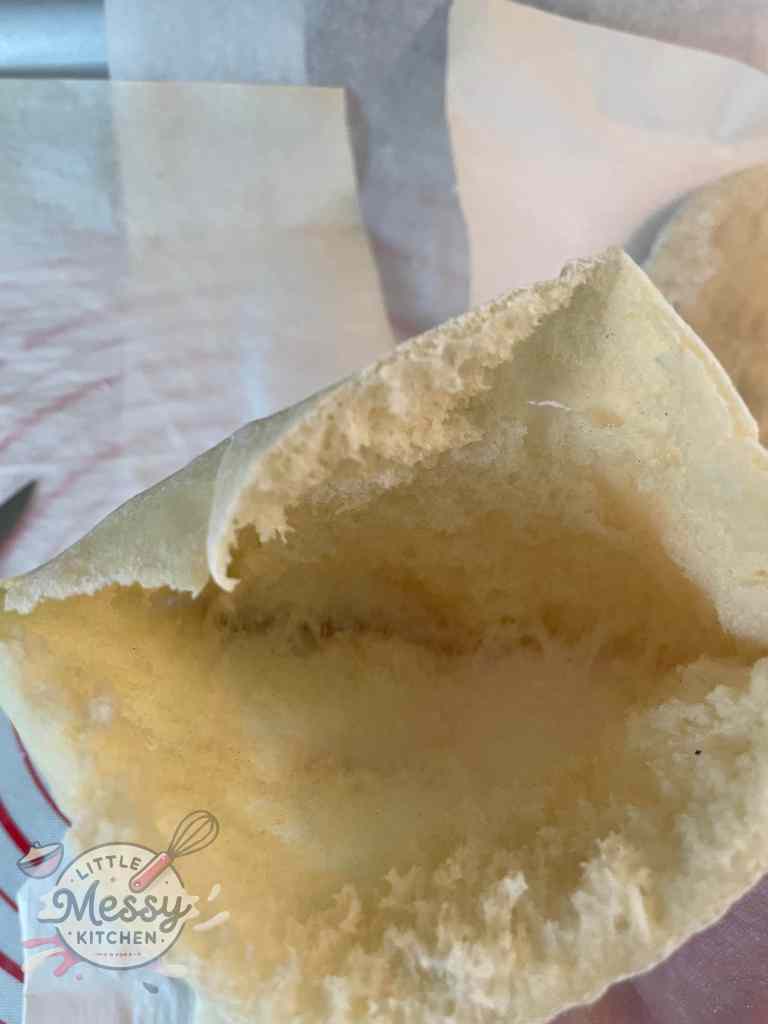Inside view of a freshly baked homemade pita bread showing the perfect pocket, ideal for stuffing with your favorite fillings.