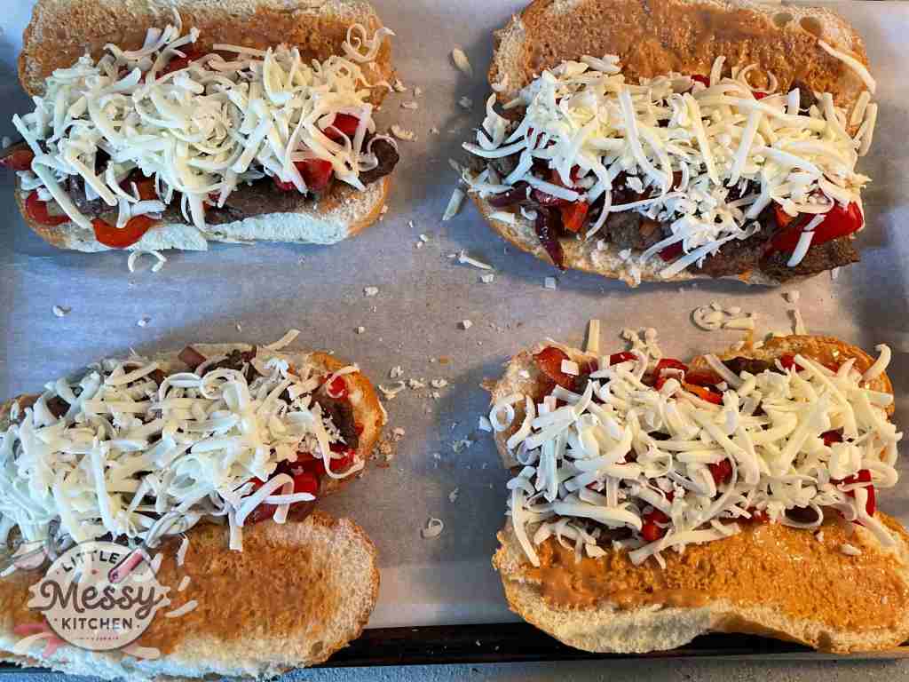 subs opened on sheet pan ready to be cooked