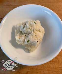 Mashed potatoes served in a white bowl.