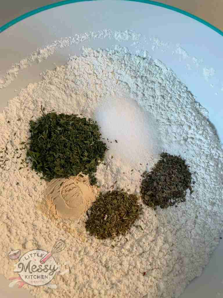 Flour and herbs in a mixing bowl.