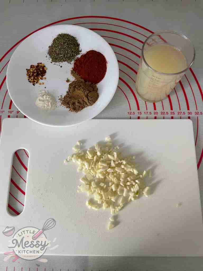 Ingredients for the marinade ready to be mixed. Garlic, lemon juice, spices.