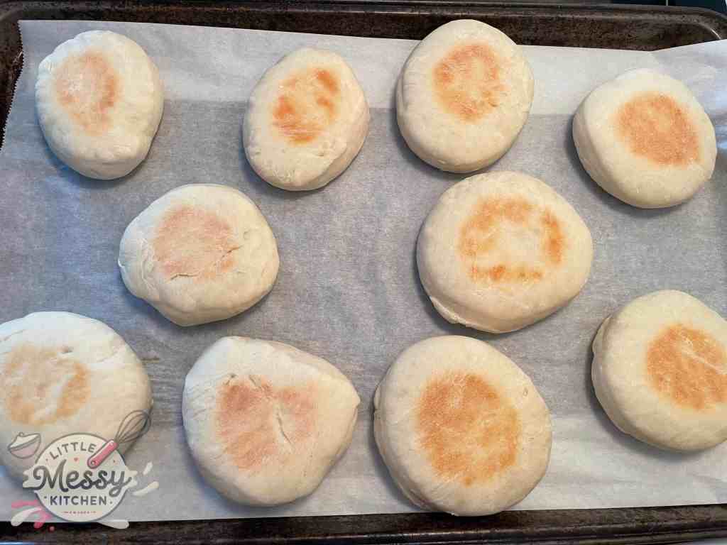Cooked english muffins on a baking sheet