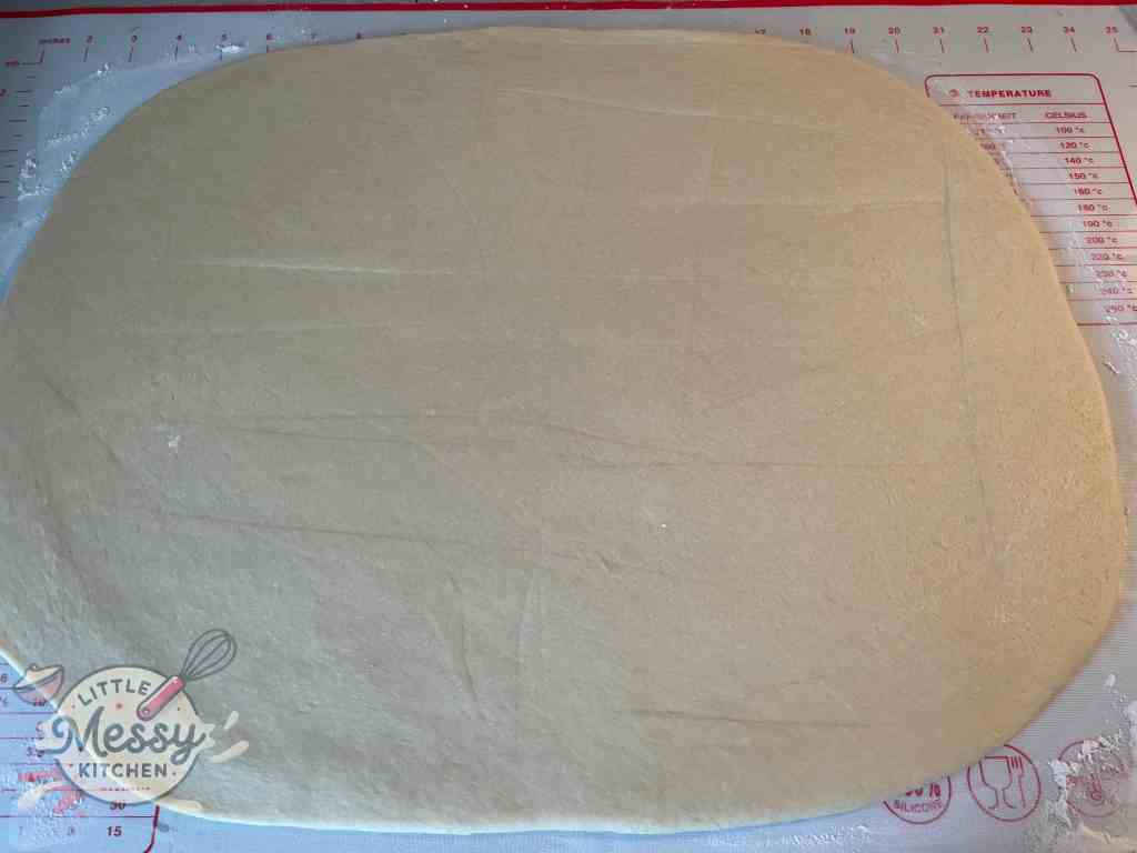 Rolled dough on a pastry mat.