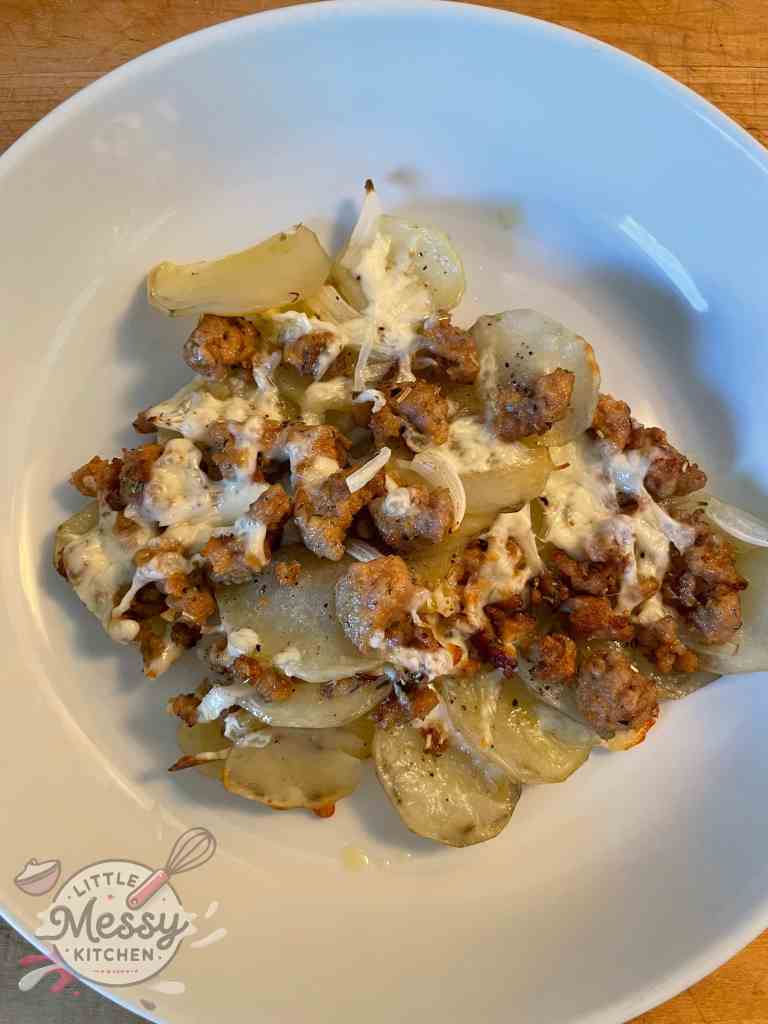 Serving of Cheesy Italian Sausage Potato Bake in a white bowl.