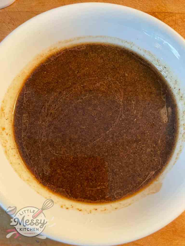 Sauce ingredients; Soy sauce, cornstarch, mirin, chicken broth, sesame oil, sugar, and black pepper mixed in a bowl.