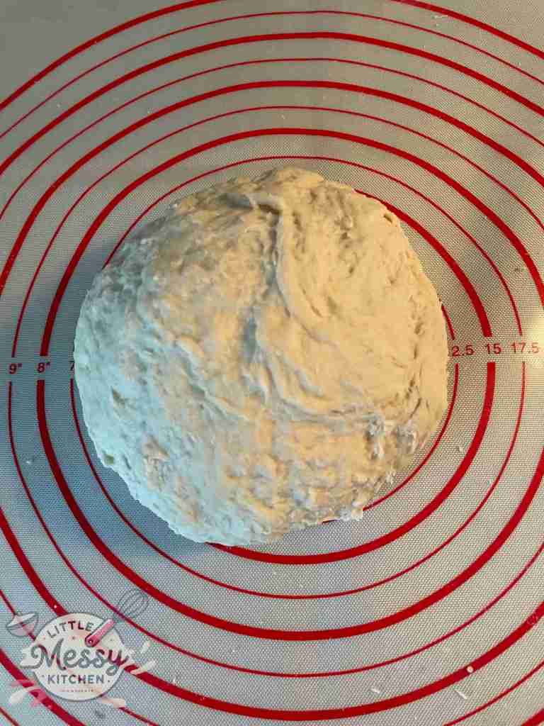 Ball of dough on a pastry mat.
