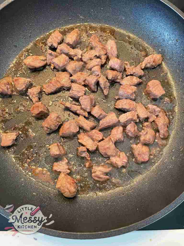 Top sirloin steak into bite-sized pieces cooking
in a skillet.