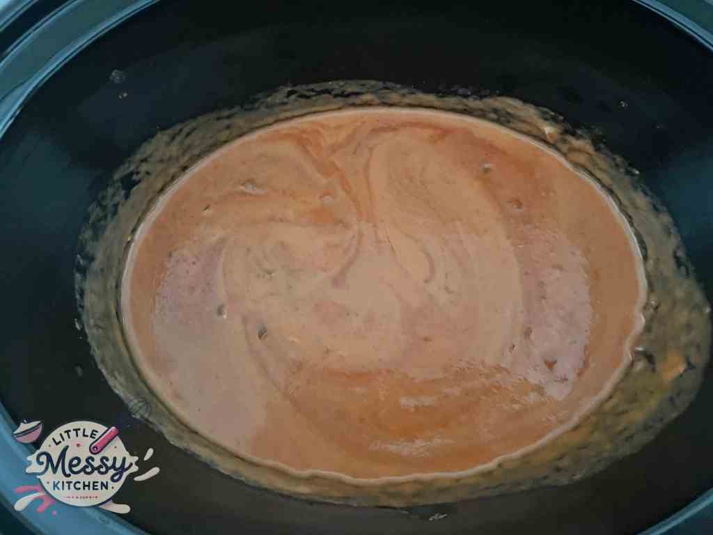 Coconut milk added to the sauce in slow cooker.