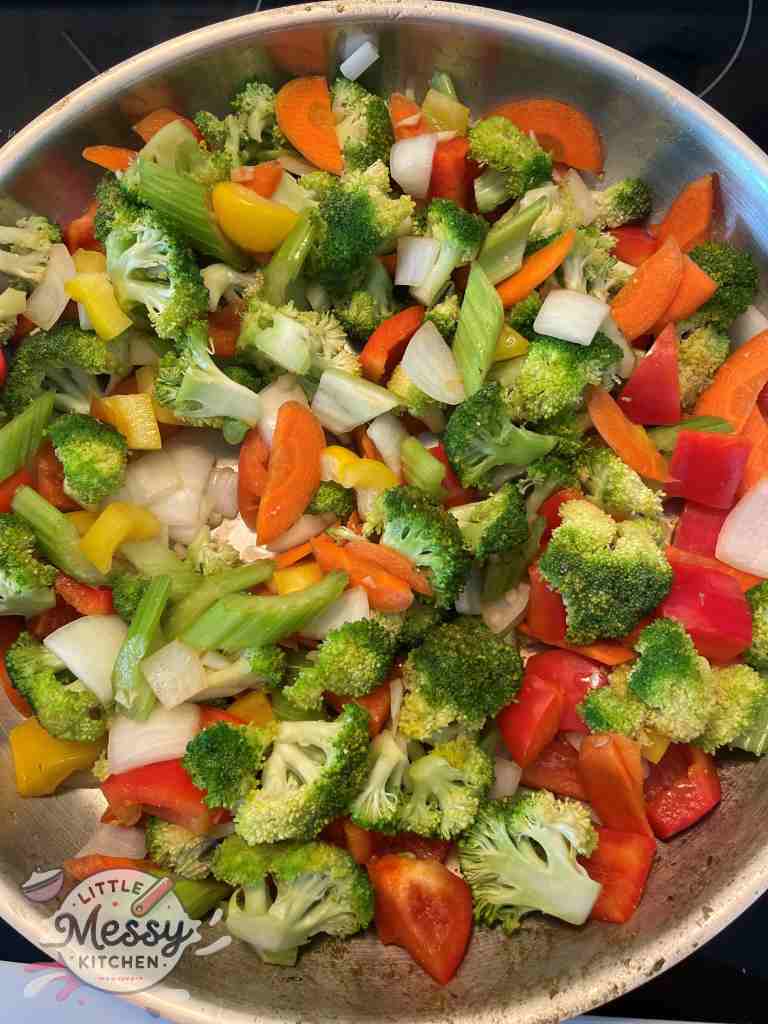 Vegetables sauteing in skillet.
