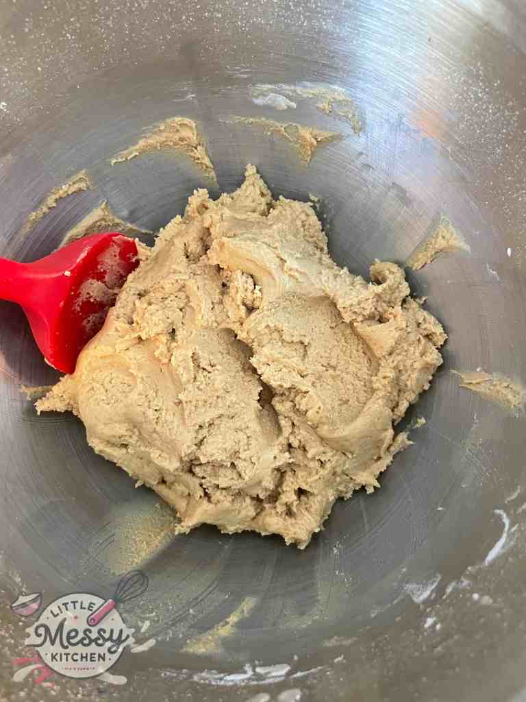Flour added to the peanut butter mixture.