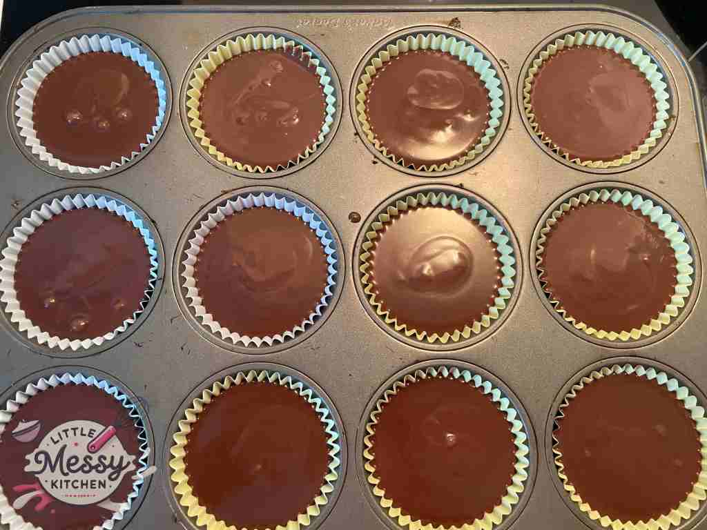 Cake batter divided in muffin cups.