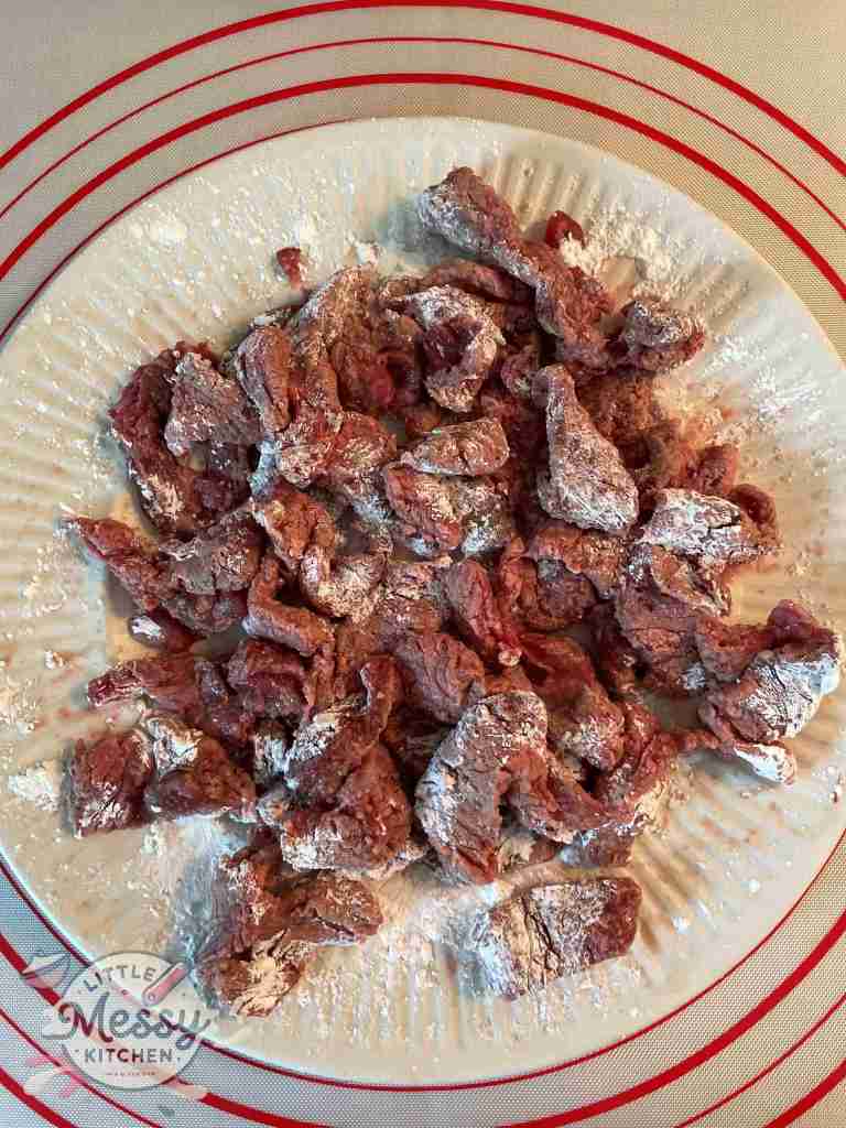 Steak slices coated in cornstarch.