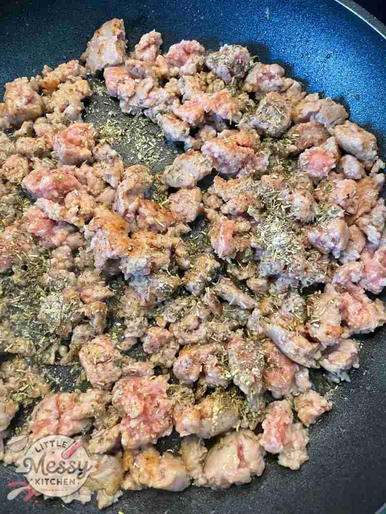 Ground sausage and spices in askillet.