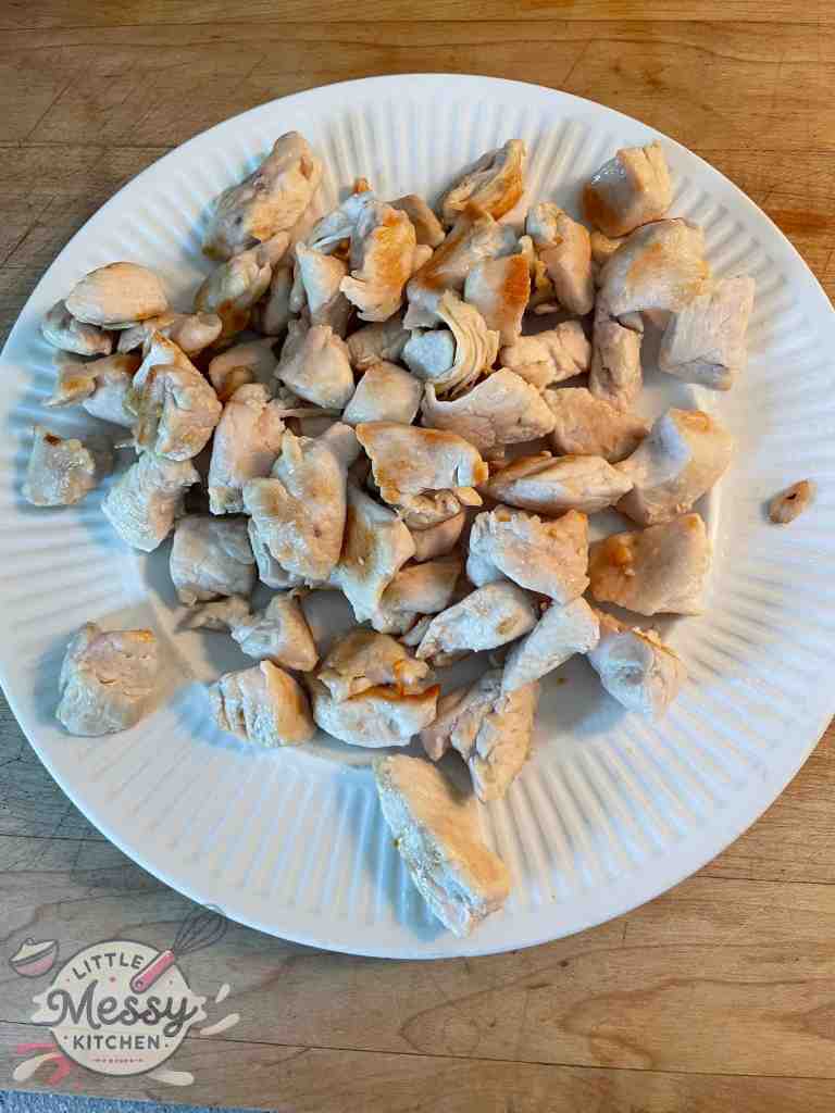 Cooked chicken pieces resting on a plate.