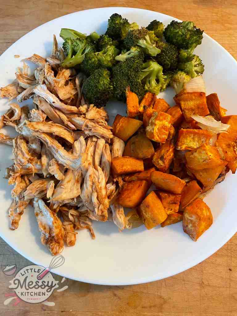 Shredded chicken, Sweet potatoes, and broccoli floret served on plate.