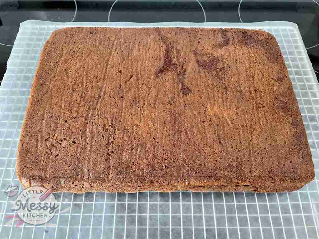 Baked carrot cake flipped cooling on a cooling rack.