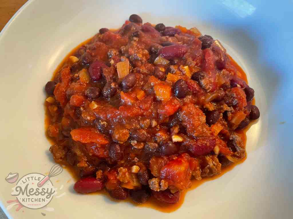 Serving of chili in a white bowl.